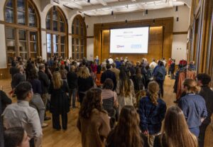 a crowd of people standing in a large room