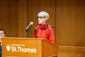 a speaker at a podium behind a microphone