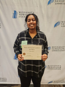 A student holding an award certificate