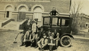 College of St. Thomas students in front of Foley Theater posing with a "Tin Lizzie." ca. 1922