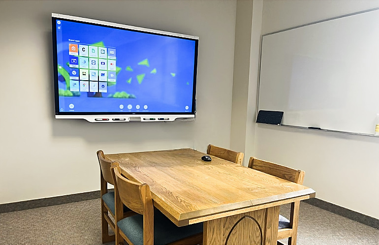 SMART board room in O'Shaughnnesy-Frey Library with table, white board, and SMART board