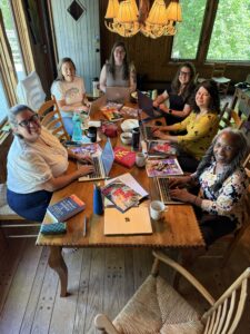 Members of the Ms. Magazine Writers in Residency workshop sitting at a table 