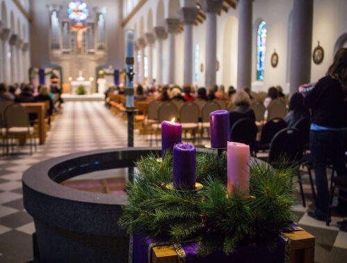 Advent wreath with 4 Advent candles and Saint Mary's Chapel in the background